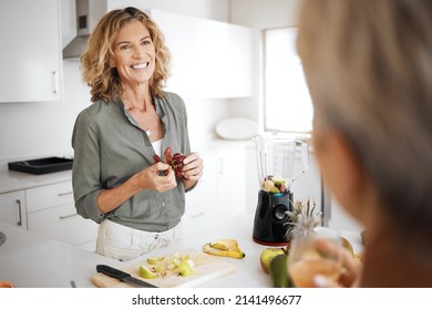 A healthy diet helps you glow. Shot of two friends having juice and smoothies together. - Powered by Shutterstock