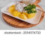 Healthy diet meal with boiled potatoes and homemade herb quark on a plate