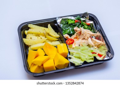 Healthy diet meal menu in bento box with shredded chicken, veggies, potato and mango fruit - Powered by Shutterstock