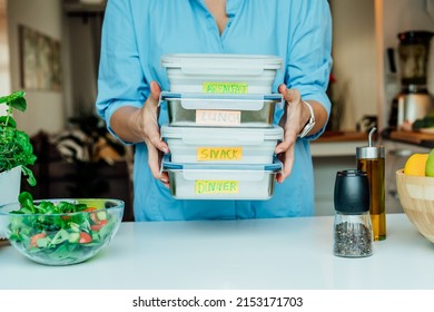 Healthy diet plan for weight loss, daily ready meal menu. Woman holding lunch boxes just cooked in advance, ready to be served. Containers with eco healthy food. Pre-cooking concept. Selective focus