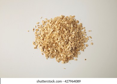 Healthy Diet Rolled Oats Isolated On White In Center, Prepared For Cooking Muesli For Breakfast, Top View