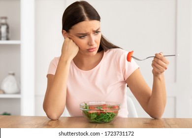 Healthy Diet. Sad Girl Eating Fresh Vegetable Salad Slimming And Losing Weight Sitting At Dinner Table At Home. - Powered by Shutterstock