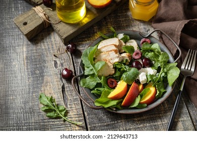 Healthy Diet Salad With Grilled Turkey, Arugula, Peach, Cherry, Feta And Vinaigrette Dressing On A Rustic Table. Keto Diet Lunch Menu.  Copy Space.