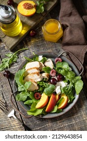 Healthy Diet Salad With Grilled Turkey, Arugula, Peach, Cherry, Feta And Vinaigrette Dressing On A Rustic Table.