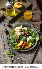 Healthy Diet Salad With Grilled Turkey, Arugula, Peach, Cherry, Feta And Vinaigrette Dressing On A Rustic Table. Keto Diet Lunch Menu.  