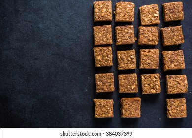 Healthy Diet Snack, Oat Flap Jack Brownie Bar. View From Overhead On Dark Slate.