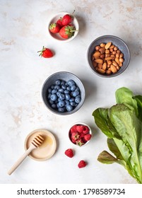 Healthy diet. Useful ingredients. Delicious summer berries. Useful nuts. Light background.