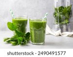 Healthy dieting and nutrition, lifestyle, vegan, alkaline, vegetarian concept. Green smoothie with organic ingredients, vegetables. Spinach smoothie.