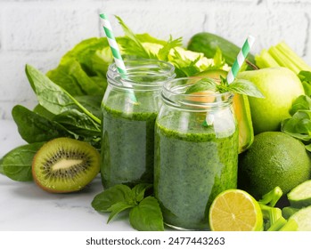 Healthy dieting and nutrition, lifestyle, vegan, alkaline, vegetarian concept. Green smoothie with organic ingredients, vegetables. Spinach smoothie.  - Powered by Shutterstock