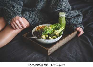 Healthy Dinner, Lunch Setting. Vegan Superbowl Or Buddha Bowl With Hummus, Vegetable, Salad, Beans, Couscous And Avocado, Smoothie On Tray And Woman In Warm Sweater Sitting Near In Bed