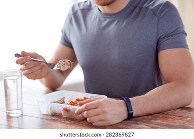 Healthy Eating, Balanced Diet, Food And People Concept - Close Up Of Male Hands Having Meat And Vegetables For Dinner With Fork And Water Glass