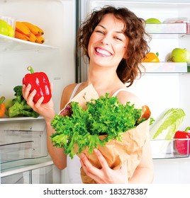 Healthy Eating Concept. Diet. Beautiful Young Woman Near The Fridge  With Healthy Food. Fruits And Vegetables In The Refrigerator. Vegan Food