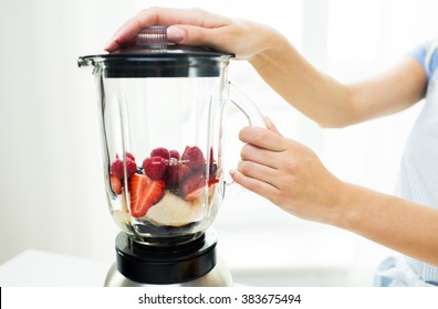 Healthy Eating, Cooking, Vegetarian Food, Dieting And People Concept -close Up Of Woman With Blender Making Fruit Shake R At Home