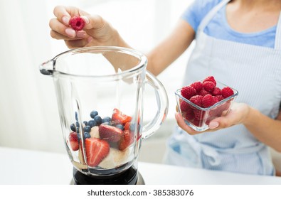 Healthy Eating, Cooking, Vegetarian Food, Diet And People Concept - Close Up Of Woman With Blender Making Fruit Shake At Home