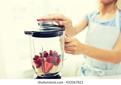 Healthy Eating, Cooking, Vegetarian Food, Dieting And People Concept -close Up Of Woman With Blender Making Fruit Shake R At Home