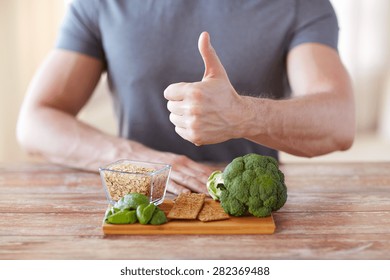 Healthy Eating, Diet, Gesture And People Concept - Close Up Of Male Hands Showing Thumbs Up With Food Rich In Fiber