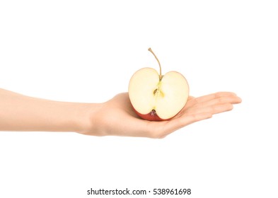 Healthy eating and diet Topic: Human hand holding a half of red apple isolated on a white background in the studio