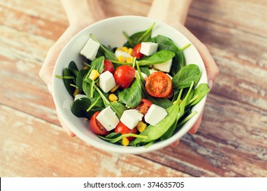 Healthy Eating, Dieting And People Concept - Close Up Of Young Woman Hands Showing Salad Bowl At Home