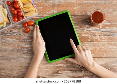 healthy eating, dieting, technology and people concept - close up of woman hands with blank tablet pc computer and food in plastic container on table at home - Powered by Shutterstock