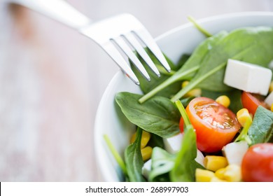 Healthy Eating, Dieting, Vegetarian Kitchen And Cooking Concept - Close Up Of Vegetable Salad Bowl And Fork At Home