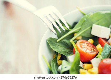 healthy eating, dieting, vegetarian kitchen and cooking concept - close up of vegetable salad bowl and fork at home - Shutterstock ID 374635276