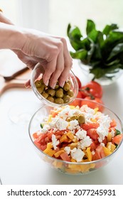 Healthy Eating. Female Hands Making Greek Salad Adding Olives To The Bowl