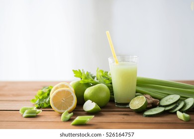 healthy eating, food, dieting and vegetarian concept - glass of green juice with fruits and vegetables on wooden table - Powered by Shutterstock