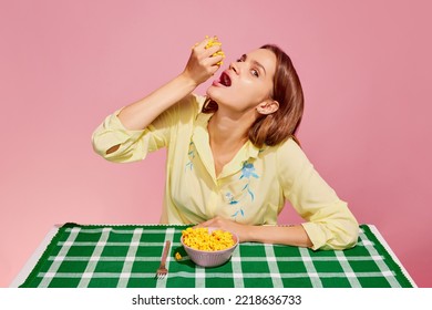 Healthy Eating. Food Pop Art Photography. Young Girl Tasting Sweet Canned Corn Isolated Over Pink Background. Concept Of Art, Creativity. Retro 80s, 70s Style. Complementary Colors. Copy Space For Ad