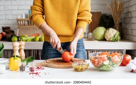 Healthy Eating. Front View Of Female Hands Making Salad Cutting Tomatoes In The Kitchen