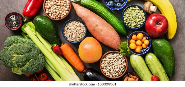 Healthy eating ingredients, banner: vegetables, fruits , legumes,berries, cereals, seeds. Vegan and vegetarian food. The concept of clean eating diet. Top view, copy space