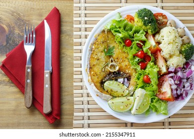 Healthy Eating Plate Of Grilled Fish And Vegetable Salad Over Rustic Wooden Table. Ketogenic And Paleolithic Diet. Top View