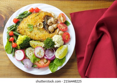 Healthy Eating Plate Of Grilled Fish And Vegetable Salad Over Rustic Wooden Table. Ketogenic And Paleolithic Diet. Top View