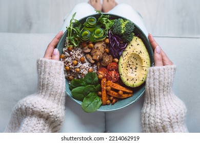 Healthy eating. Plate with vegan or vegetarian food in woman hands. Healthy plant based diet. Healthy dinner. Buddha bowl with fresh vegetables