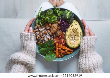 Healthy eating. Plate with vegan or vegetarian food in woman hands. Healthy plant based diet. Healthy dinner. Buddha bowl with fresh vegetables