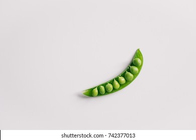 Healthy Eating / Portion Control Concept. Single Pod Of Pea On White Background. Top View With Copy Space.