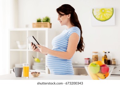 Konzept von gesundem Essen, Schwangerschaft und Menschen - schwangere Frau mit Tablet PC mit Frühstück in der Küche