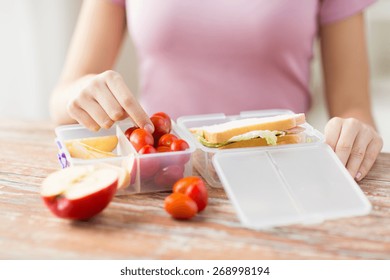 Healthy Eating, Storage, Dieting And People Concept - Close Up Of Woman With Food In Plastic Container At Home Kitchen