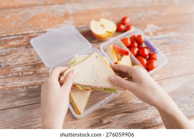 Healthy Eating, Storage, Dieting And People Concept - Close Up Of Woman With Food In Plastic Container At Home Kitchen