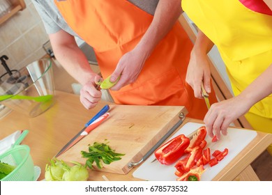 Healthy Eating, Vegetarian Food, Cooking, Weight Loss And People Concept. Closeup Couple Woman And Man In Kitchen At Home Slicing Vegetables For Salad