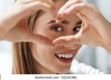 Healthy Eyes And Vision. Portrait Of Beautiful Happy Woman Holding Heart Shaped Hands Near Eyes. Closeup Of Smiling Girl With Healthy Skin Showing Love Sign. Eyecare. High Resolution Image - Shutterstock ID 522191386