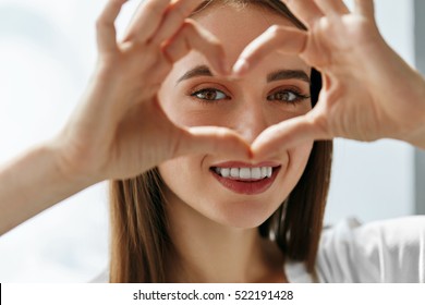 Healthy Eyes And Vision. Portrait Of Beautiful Happy Woman Holding Heart Shaped Hands Near Eyes. Closeup Of Smiling Girl With Healthy Skin Showing Love Sign. Eyecare. High Resolution Image - Shutterstock ID 522191428