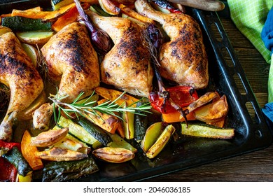 Healthy family meal with roasted chicken legs and oven baked vegetables served on a baking tray - Powered by Shutterstock