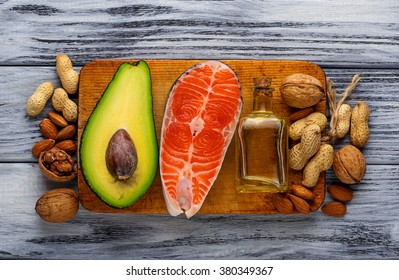 Healthy fat salmon, avocado, oil, nuts. Selective focus - Shutterstock ID 380349367