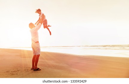 Healthy father and daughter playing together at the beach carefree happy fun smiling lifestyle - Powered by Shutterstock