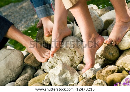 Healthy feet series: feet of men and women of different ages on stones