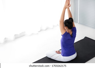 Healthy Female Practicing Basic Yoga At Home. Beginner Yoga Woman  Practice Basic Yoga Pose During Covid-19 Home Quarantine Period.  Stretching & Balance Exercise At Home On Quarantine Period Concept.