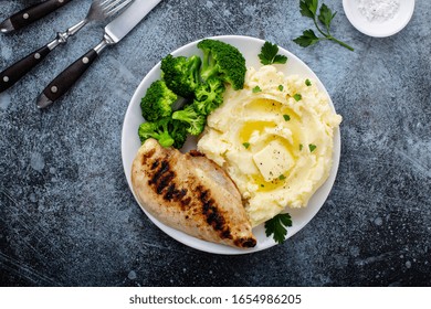 Healthy And Filling Dinner With Grilled Chicken Breast, Mashed Potatoes And Broccoli Overhead Shot