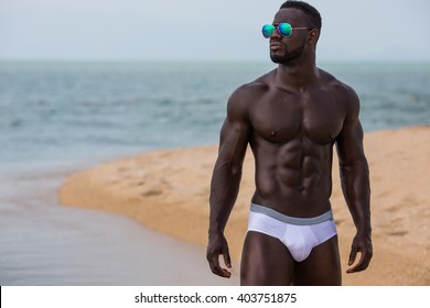 Healthy, fit and muscular black african american man on a beach 