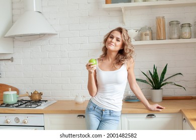 Healthy Fit Woman With Green Apple At Home Kitchen