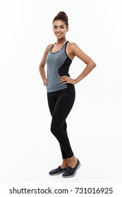 Healthy and Fitness concept - portrait of African American girl posing with fitness clothes over white studio background.